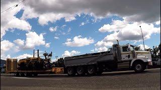 WESTERN STAR 4900 TRI-DRIVE DUMP TRUCK & CAT AP1055B PAVER LAYING ASPHALT.