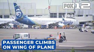 Anxious passenger walks onto wing of jet at Seattle airport