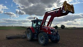 Tractors and diggers. Drilling new grass