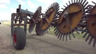 8 Pin Wheel Hydraulic Lift Stickrake (Rock Rake) towing on farm - Multi Farming Systems