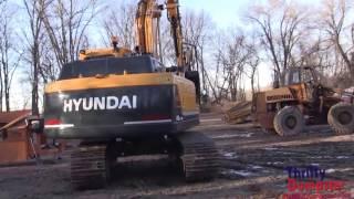 Hyundai 140 Excavator loading unloading and breaking crushing concrete