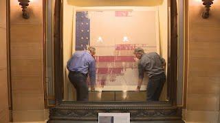 Hands on with History: MN Historical Society staff change out the rotunda’s battle flags