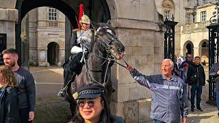 GRINNING IDIOT GRABS AND TUGS THE REINS - COMPLETELY IGNORING THE NEW RULES at Horse Guards!