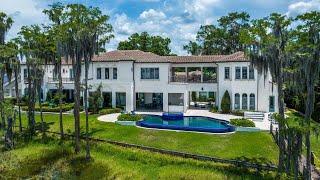 This $6,670,000 Elegant Home in Orlando has a resort style backyard and a stone driveway