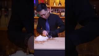 BB Bartender cuts diamond ice with hand cubes to make a cup of mellow and elegant cocktail