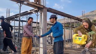 Abbas and his father help the workers in building the roof of the new house