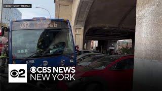 MTA bus crashes onto a sidewalk in Queens, injuring at least two passengers