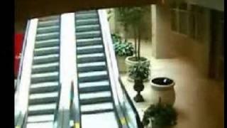 Old man falls on escalator