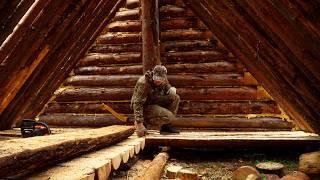 A MAN ALONE BUILDS A LARGE LOG HOUSE IN THE WILD FOREST. THE WOODEN FLOOR IS READY!