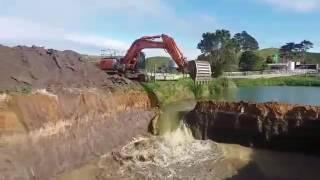 Hitachi Zaxis 350 LCH releasing sandstone dam