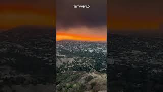 LA skies glow red amid raging wildfires