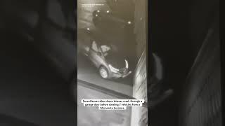 Surveillance video shows thieves crash through a garage door before stealing 7 cars