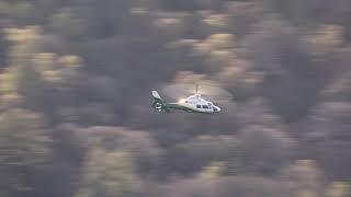 Great North Air ambulance flying low over Ullswater in the Lake District UK