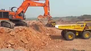 TATA Hitachi EX1200 Excavator Loading Dumpers cat773E and operator view