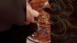 The wooden pad is inlaid with gold thread