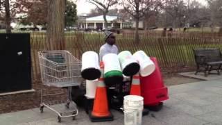 Street drummer plays buckets