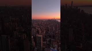 Vertical views showcase Manhattan and New York City skyline at sunset, highlighting skyscrapers