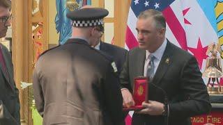 Edward Kelly of International Association of Firefighters presents Medal of Valor to Lt. Tchoryk’s s