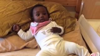 Baby chills on crumpled pillow before hospital appointment