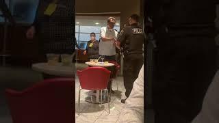 Drunk guy getting arrested in the DTW Delta Sky Club