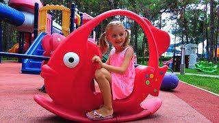 Polina plays on new playground for kids.