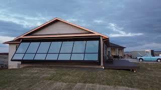 Full Glass Powerlift Hydraulic Architectural door showing Sunroom