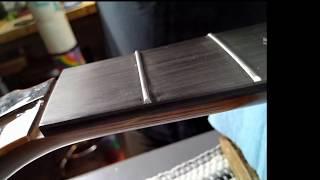 Fret end grooming with diamond fret file.