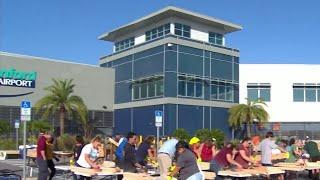 Volunteers turn Orlando airport parking lot into workshop to build beds for children