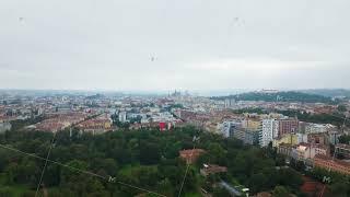 Camera moving right above the city of Brno, Czech Republic. Lush green trees of Park Luzanky fill