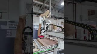 Hotel furntiure factory tour : worker is doing data input before working on a CNC machine