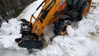 JCB Backhoe Collecting SNOW and Loading in Tractor. New tractor JCB 3CX - 2020