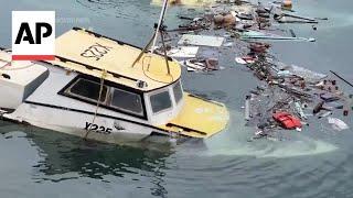 Fishermen in Barbados assess the damage to their boats from Hurricane Beryl