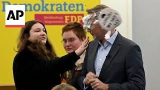 Protester throws cake at ex-German Finance Minister Christian Lindner