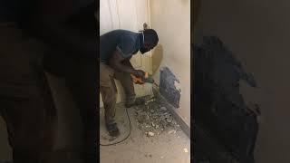 Building in Ghana - How to peel the affected area of a wall using a chiseling machine.