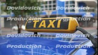 Yellow taxi sign on a car roof. Dubai Taxi.