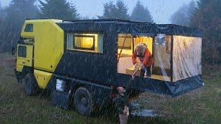 CARAVAN CAMPING WITH A WOOD-BURNING STOVE IN THE RAIN