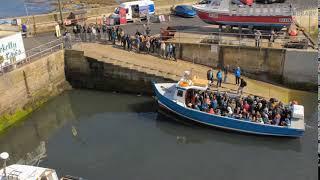 Timelapse of tourists boarding a boat to take them to the Farne Islands, Seahouses Harbour, Northumb