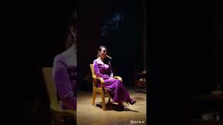 Woman on a Chair Smoking a Cigar