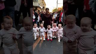 Grandma takes her grandchildren out and attracts the attention of passers-by.