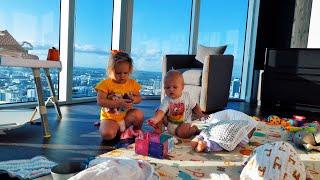 The sweet little ones, Naomi and David, are happily playing at home.