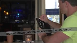 Man in cafe drawing coffee list with chalk