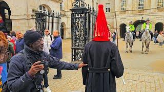 GET OFF! ODD MOMENT PHOTOGRAPHER TOUCHES THE GUARD AFTER NOT PAYING ATTENTION at Horse Guards!