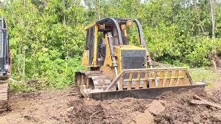 Caterpillar bulldozer working mowing on the mountain