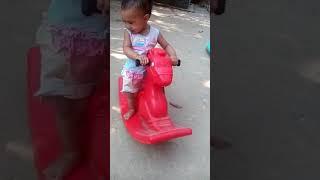 Little baby ride a plastic horse