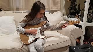 Clara learning to play the electric guitar 