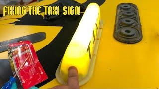 Fixing the taxi sign on the demon!