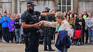 POLICE ACT FAST WHEN A LADY DARTS OUT FROM THE CROWD DURING THE GUARD CHANGE at Horse Guards!