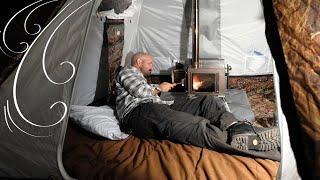 Man Sleeps in a Hot Tent with Wood Stove