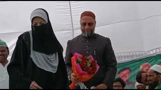 Mrs Nadia siddiqui presenting a bouquet at election meet kausambhi to Barister Mr owaisi .