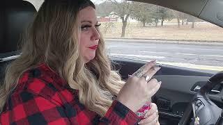 Smoking a Marlboro Red cigarette while driving